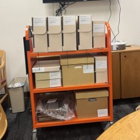 The cart of archive boxes that Emily pulled.