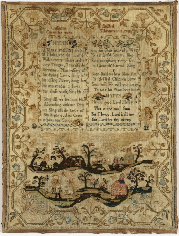 Embroidered sampler with verse in the middle and a country scene at bottom